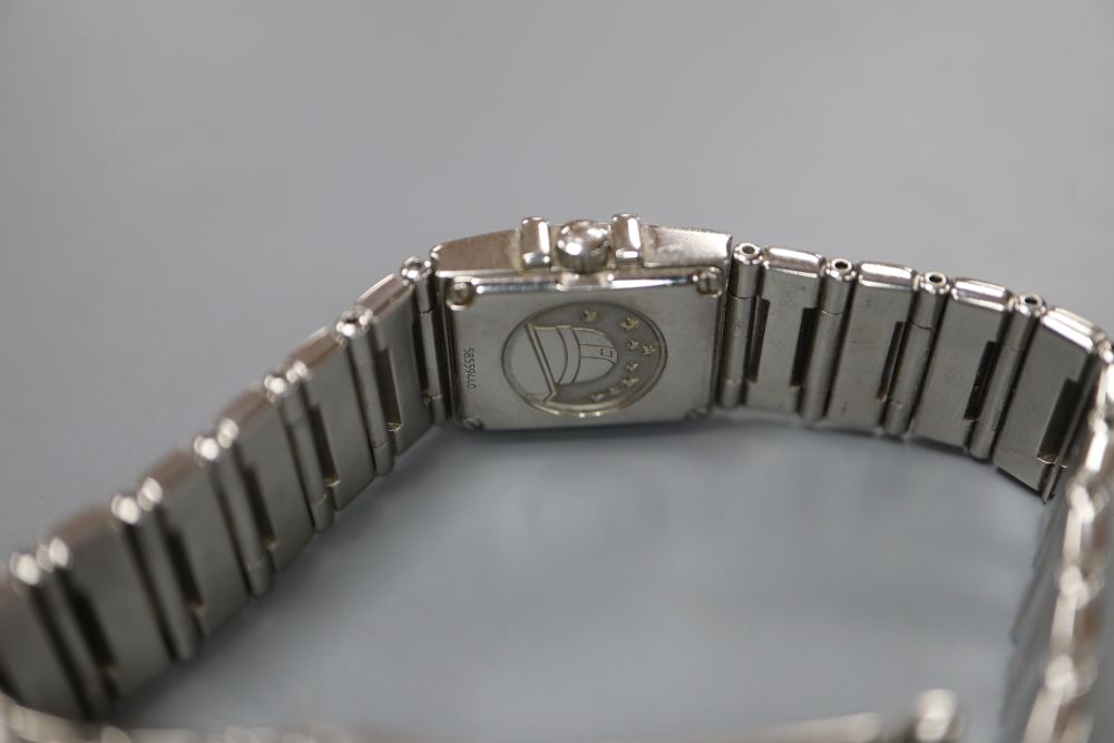 A ladys stainless steel Omega Constellation quartz? wrist watch, with square mother of pearl dial and diamond set bezel,